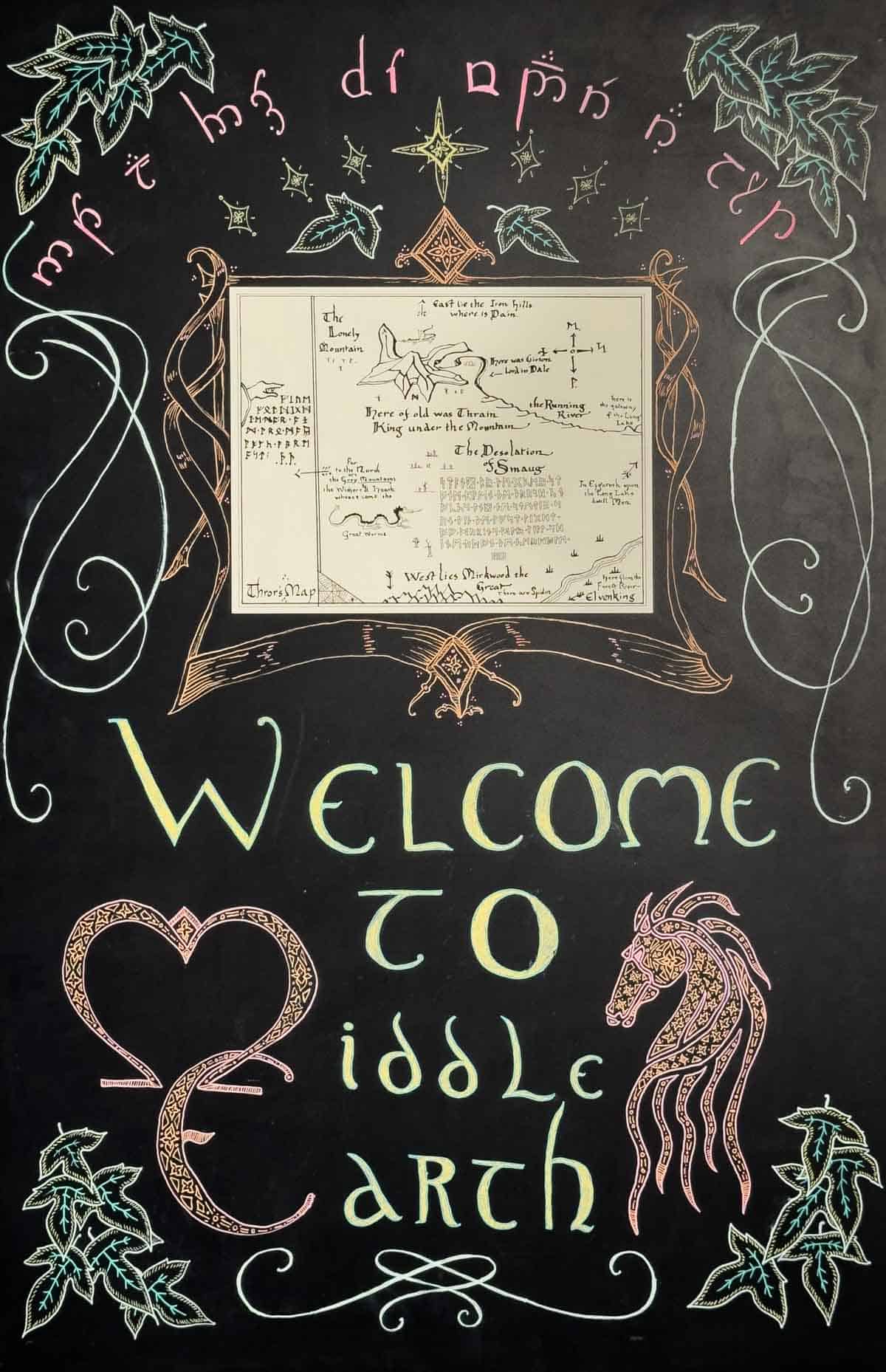 chalk hand lettered sign with a map reading Welcome to Middle-earth.