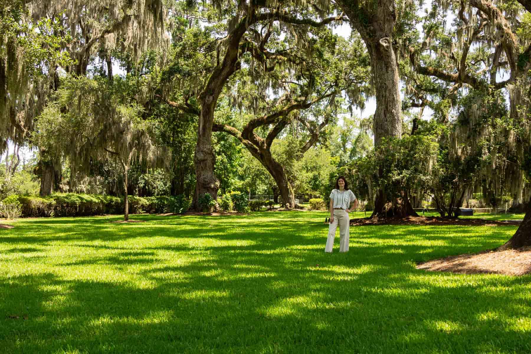 beth standing under live oaks.