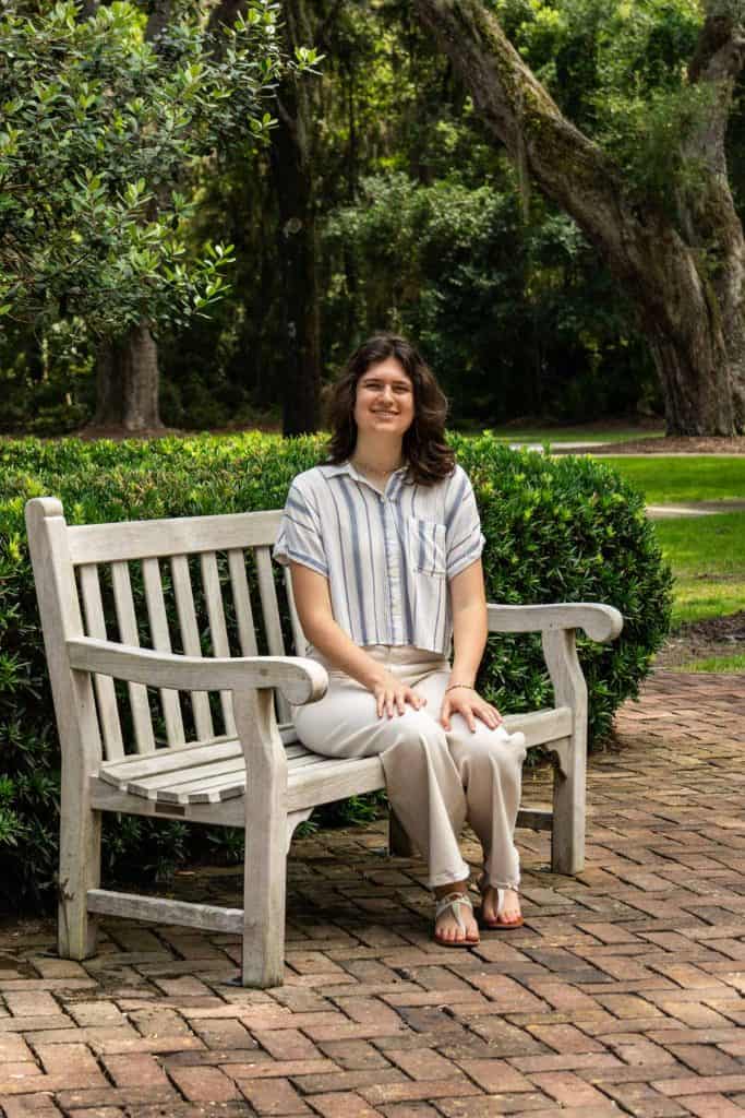 beth sitting on a wooden bench.