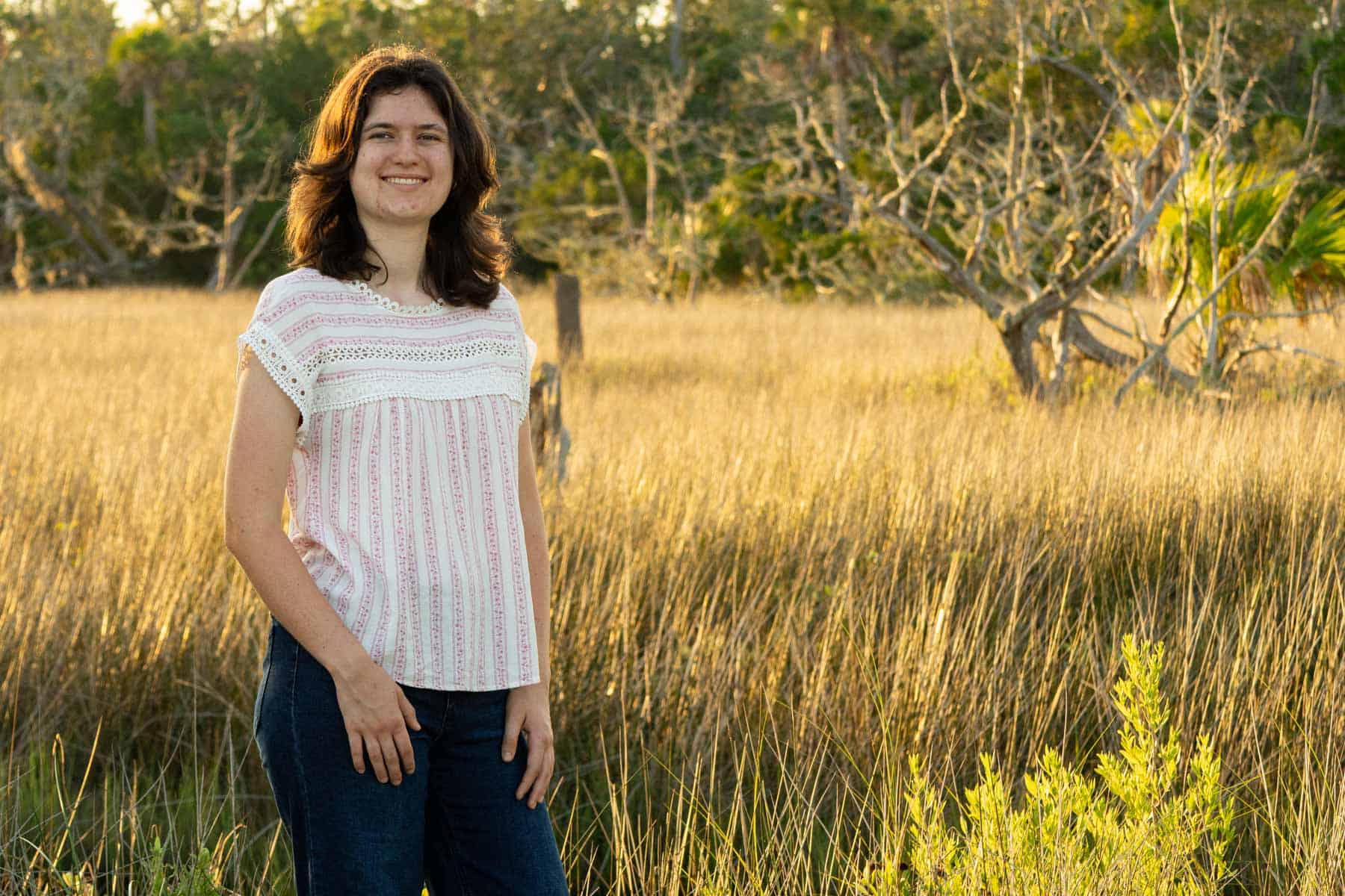 beth standing near the marsh.