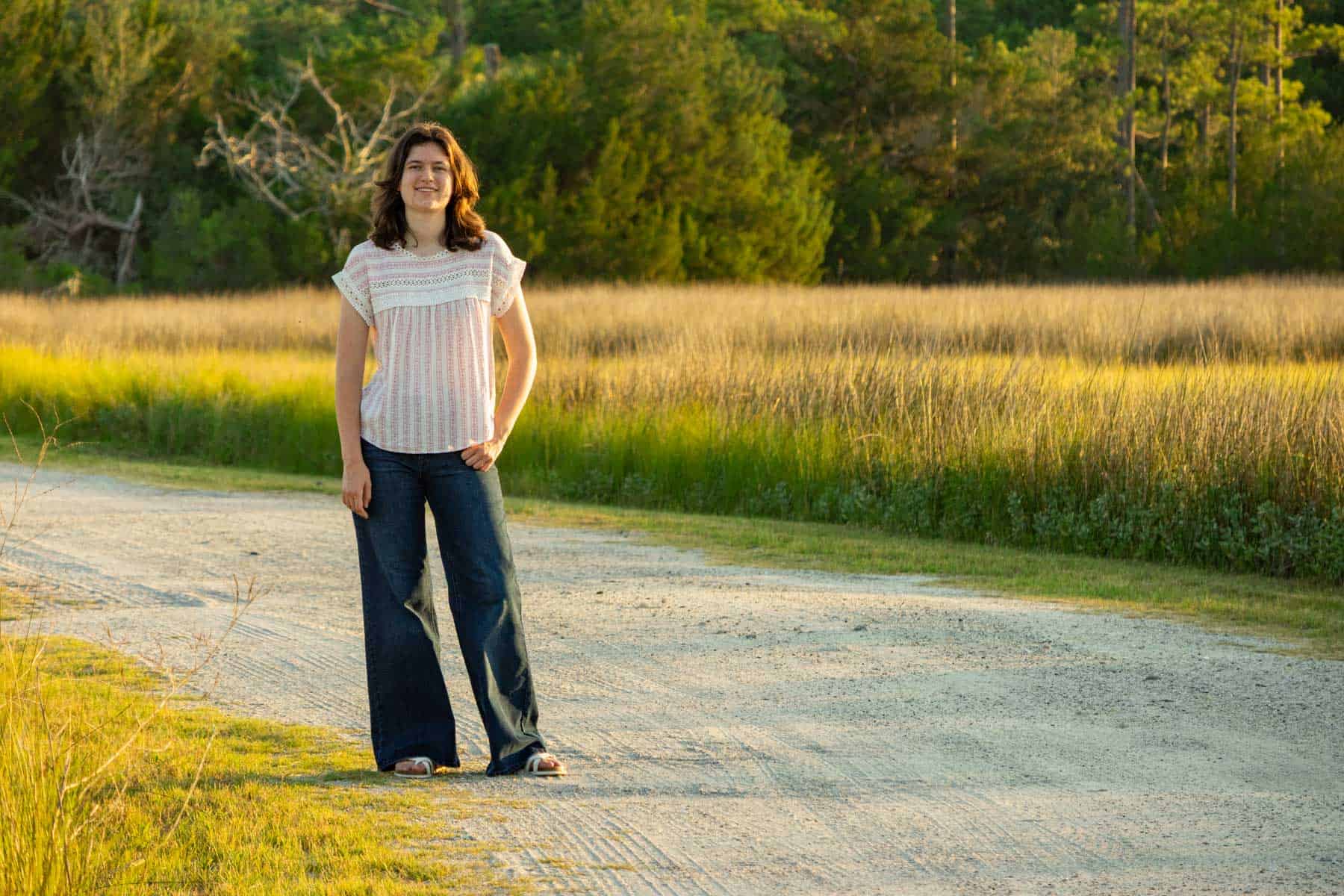 beth standing on the road in the marsh.